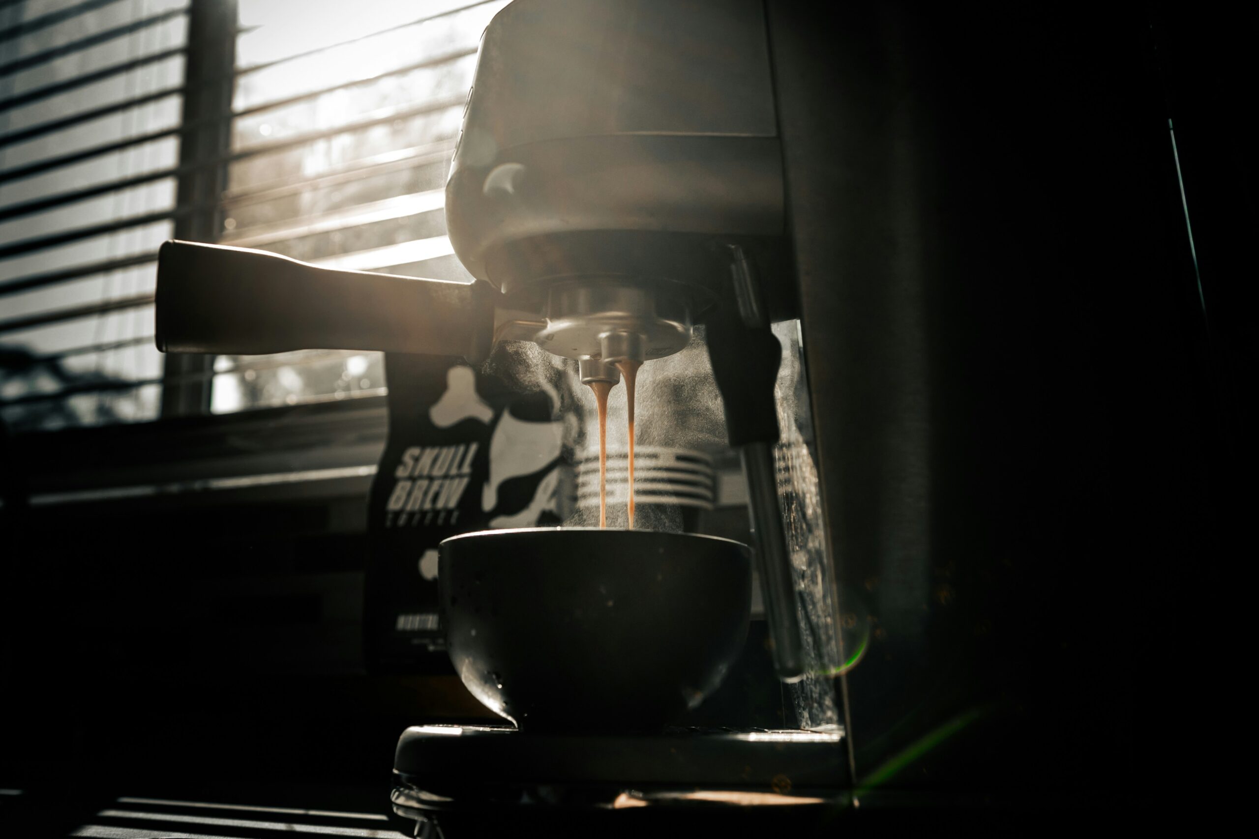 Modern drip coffee maker on a dark counter