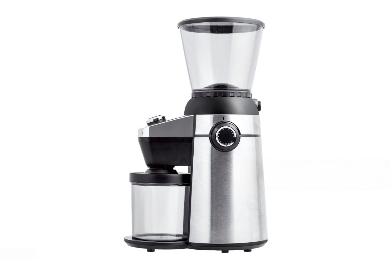 Electric coffee grinders on a kitchen counter with beans and mugs